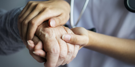 younger hands hold older hand younger hands hold older hand